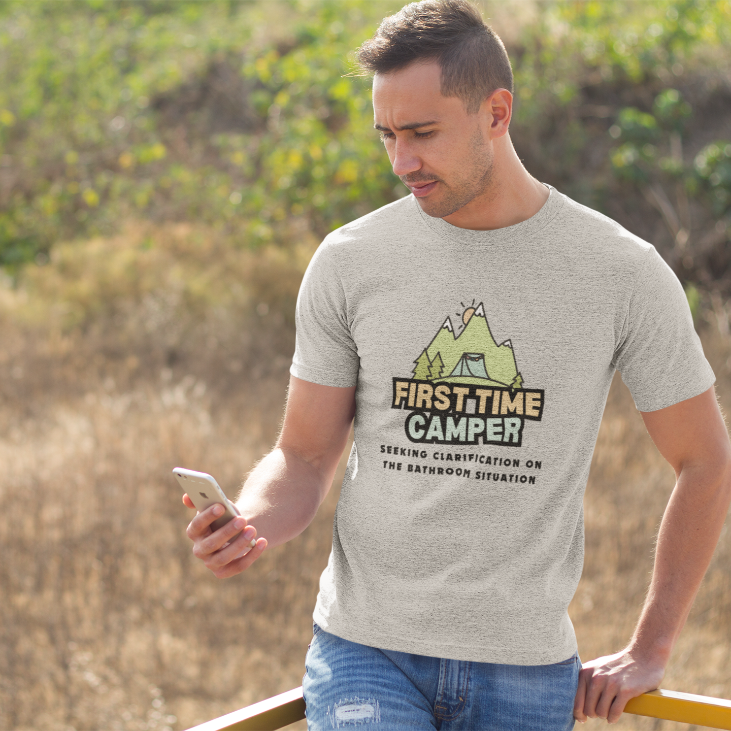 Man wearing a 'First Time Camper' t-shirt in a natural setting
