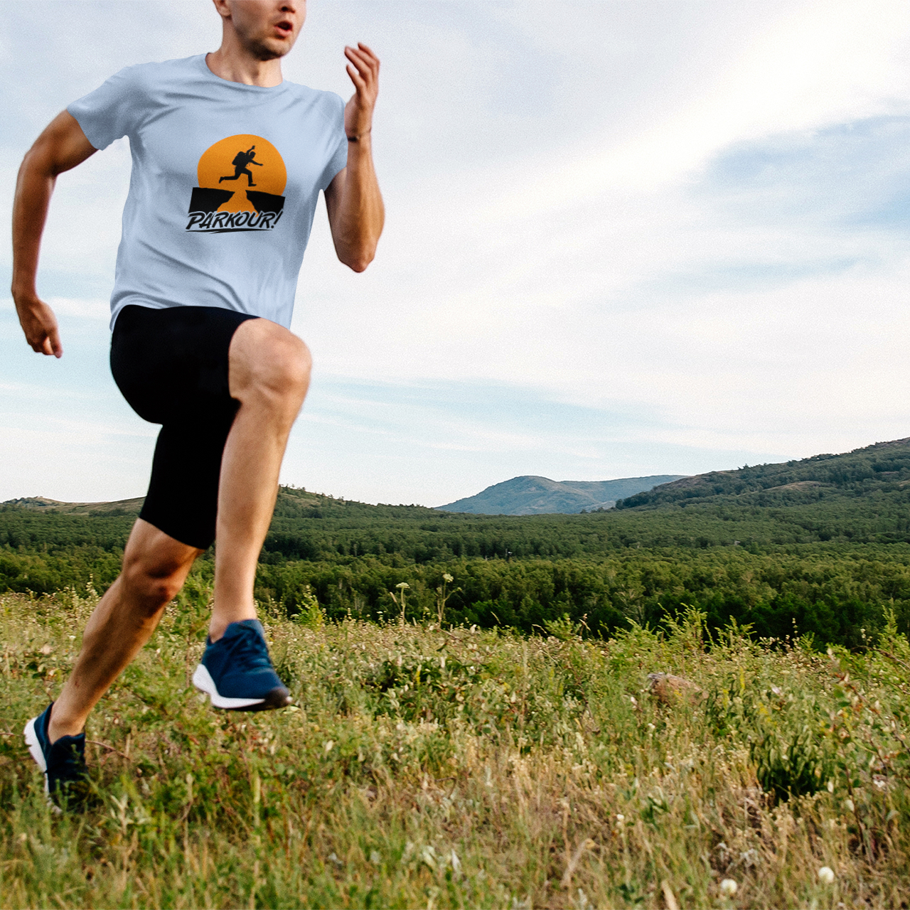 Person running outdoors in a scenic landscape with mountains and greenery.