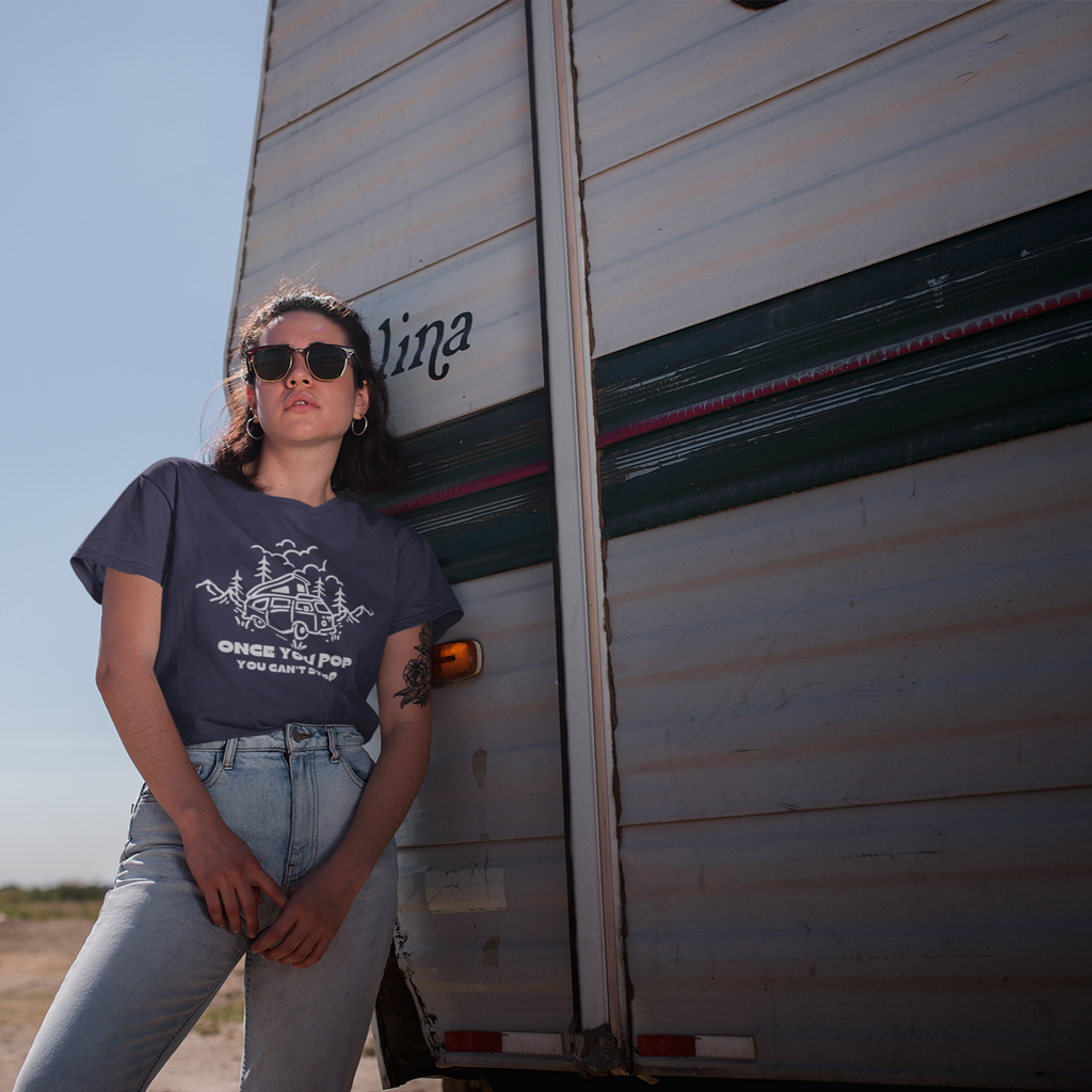 Person standing next to a trailer with a clear sky background